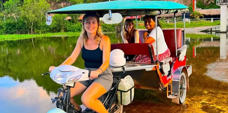Guests in Seth's turquoise tuk-tuk